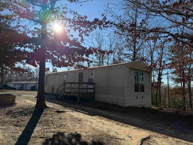 a view of a backyard with large trees