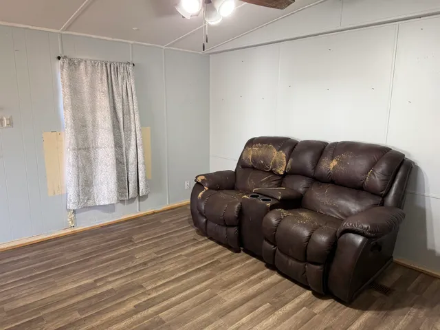 a blue couch sitting on top of a wooden floor