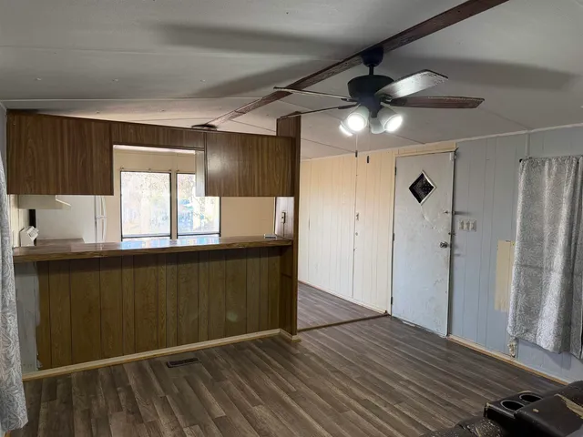 a kitchen with granite countertop a refrigerator and a sink
