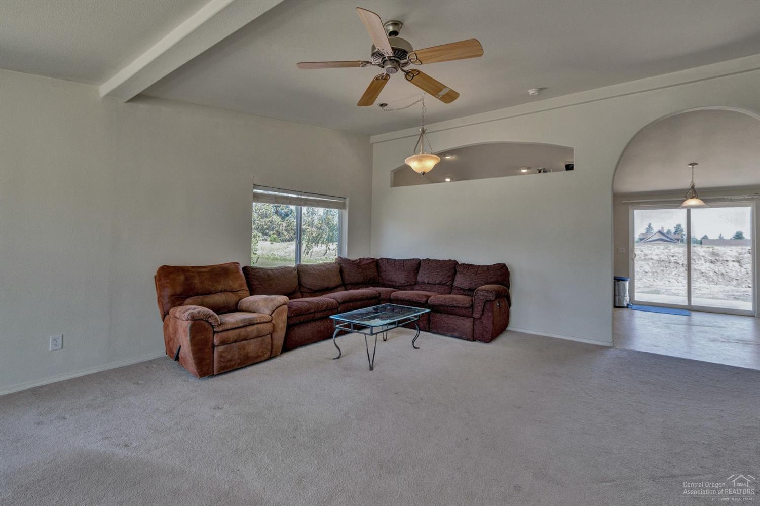 67252 Gist Road Bend, OR 97703 - Photo 6 of 24 a living room with furniture a chandelier and a window