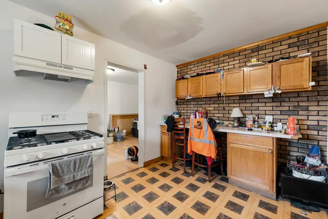 a kitchen with refrigerator and cabinets
