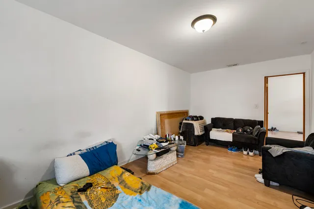 a bedroom with furniture and a wooden floor