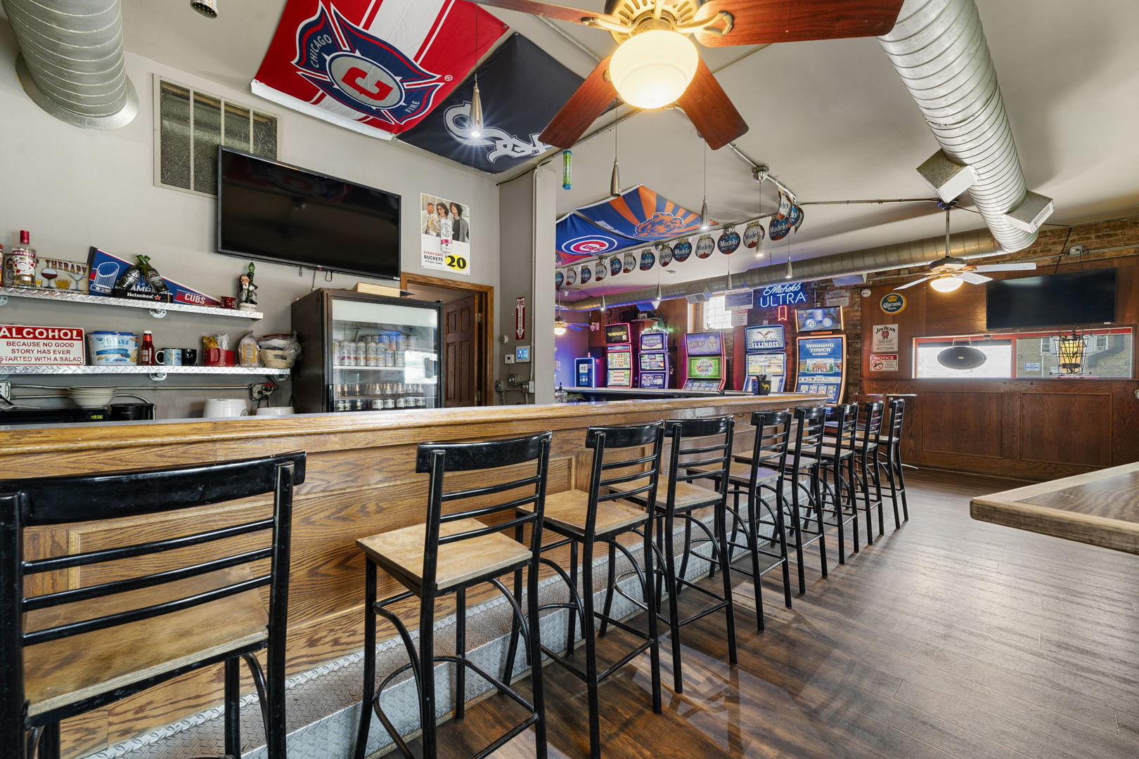 6021 South Archer Road Summit, IL 60501 - Photo 20 of 40 a room with stainless steel appliances kitchen island granite countertop a table chairs and a flat screen tv