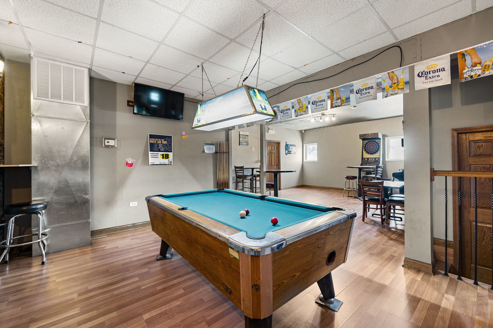 6021 South Archer Road Summit, IL 60501 - Photo 25 of 40 a room with wooden floor table and chairs