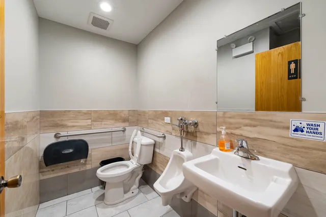 a bathroom with a toilet sink and mirror