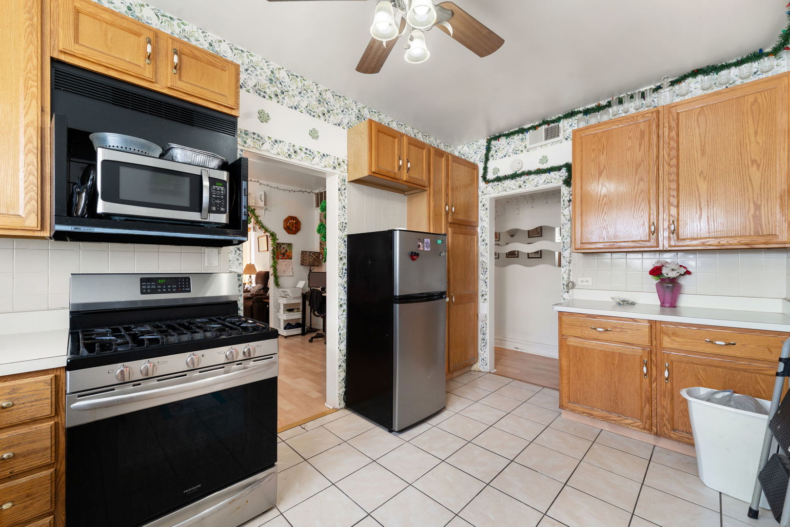 6021 South Archer Road Summit, IL 60501 - Photo 6 of 40 a kitchen with stainless steel appliances a stove microwave and cabinets