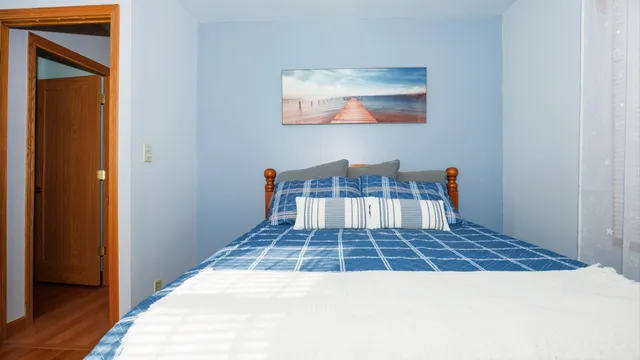 a bed room with a bed and a chair