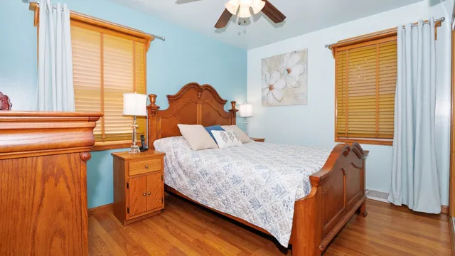 a bedroom with a bed and wooden floor