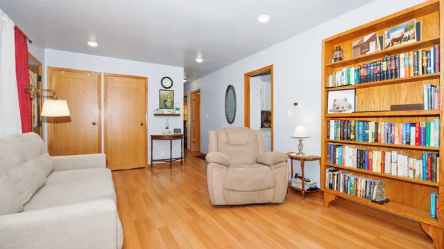 a living room with furniture and a book shelf