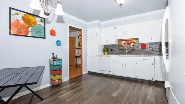 a very nice looking room with wooden floor and furniture