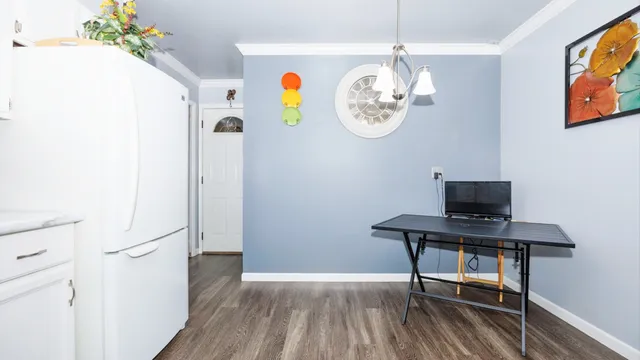 a view of a workspace with furniture and wooden floor