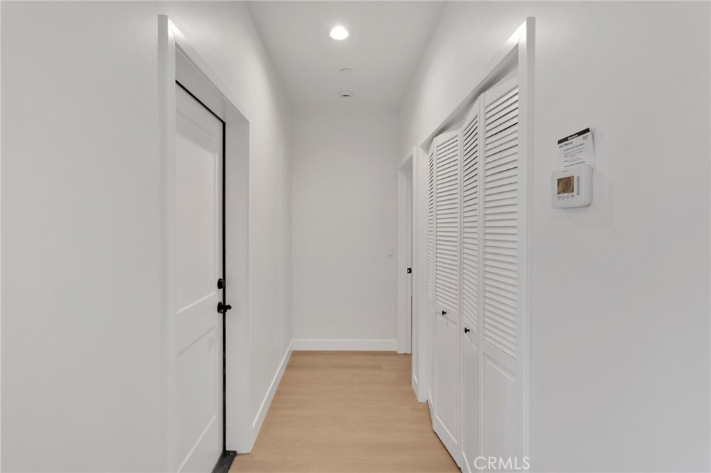 15561 Desert Star Road Apple Valley, CA 92307 - Photo 11 of 22 a view of a hallway with wooden floor