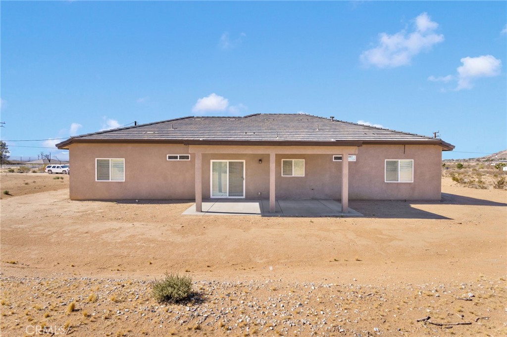 15561 Desert Star Road Apple Valley, CA 92307 - Photo 21 of 22 a front view of a house with a yard and garage