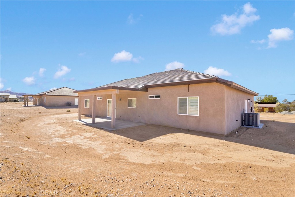 15561 Desert Star Road Apple Valley, CA 92307 - Photo 22 of 22 a front view of a house with a yard