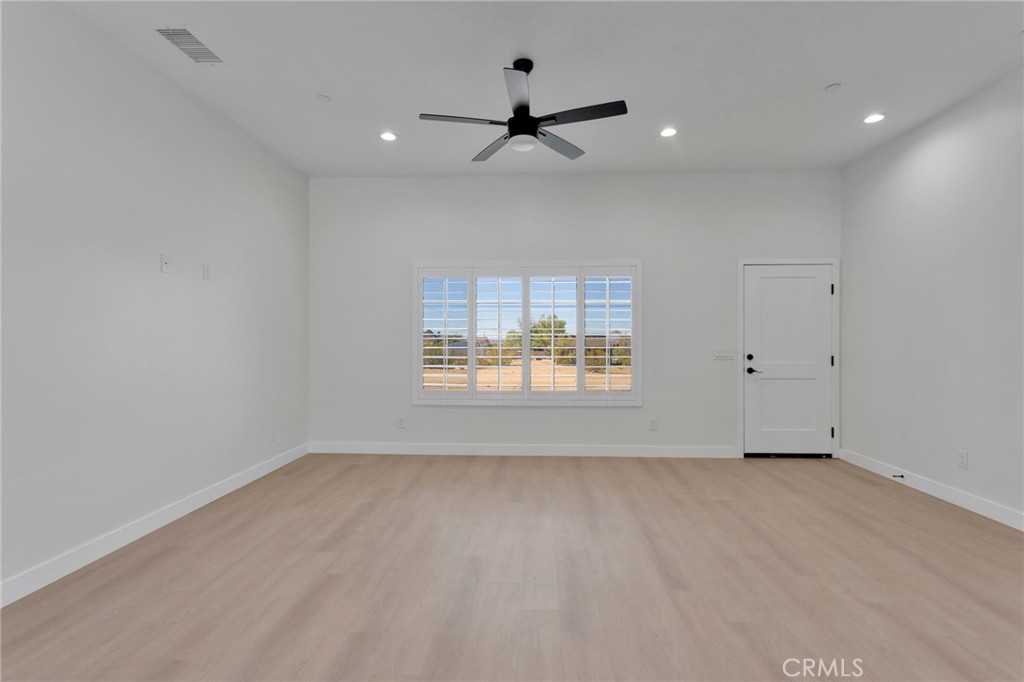 15561 Desert Star Road Apple Valley, CA 92307 - Photo 4 of 22 an empty room with a window
