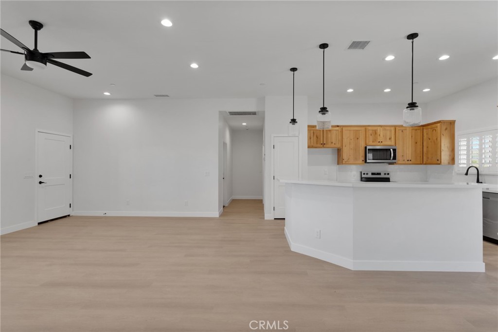 15561 Desert Star Road Apple Valley, CA 92307 - Photo 6 of 22 a view of kitchen with kitchen island and stainless steel appliances