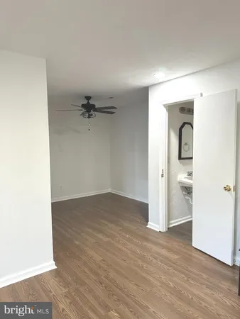 an empty room with a gallery and wooden floor