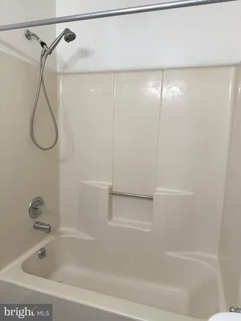 a bathroom with a shower and a bath tub