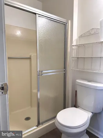 a bathroom with a toilet a sink and a window