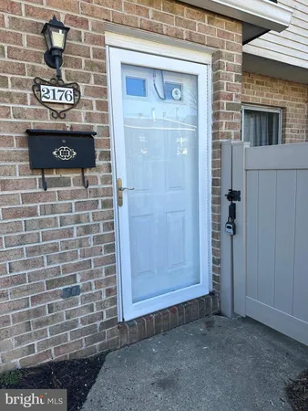 a view of a door with brick walls