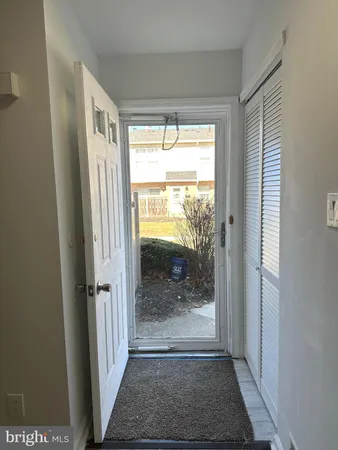 a view of a hallway with a glass door and glass door