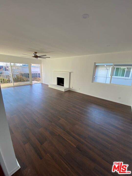 a view of a room with kitchen flooring and wooden floor