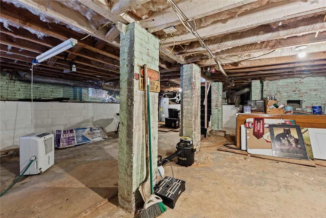 2028 Moultrie Square Anderson, SC 29621 - Photo 24 of 30 Exposed wood joists and concrete floors define this unfinished basement with brick support pillars.