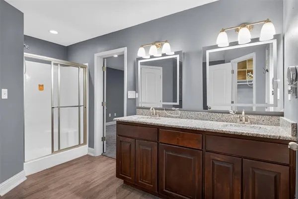 a bathroom with a double vanity sink and a mirror