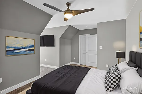 a bedroom with a bed and a painting on the wall