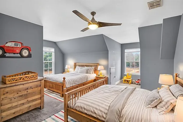 a bedroom with two beds and a window