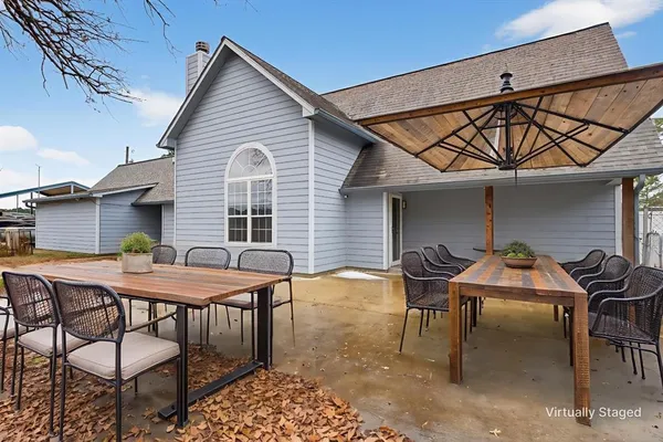 a patio with table and chairs