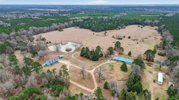 an aerial view of a house with a yard