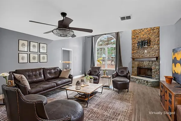 a living room with furniture a fireplace and a flat screen tv