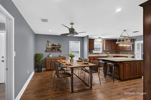 a view of a dining room with furniture and wooden floor