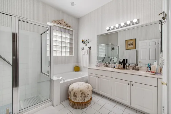 a spacious bathroom with a sink a mirror a vanity and shower