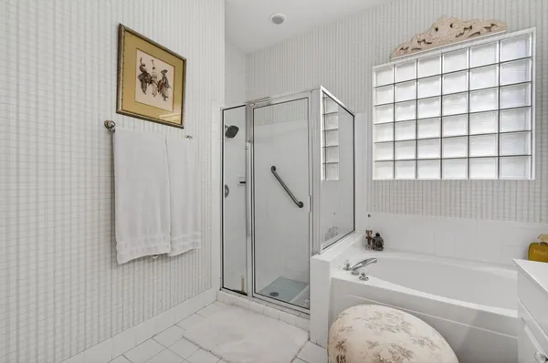 a bathroom with a bathtub and a shower
