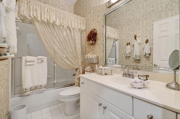a bathroom with a granite countertop sink a toilet and a mirror