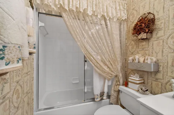 a bathroom with a sink toilet and shower