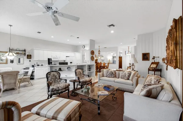 a living room with lots of furniture and a large window