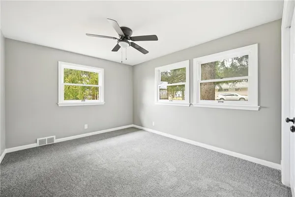 a view of an empty room with a window