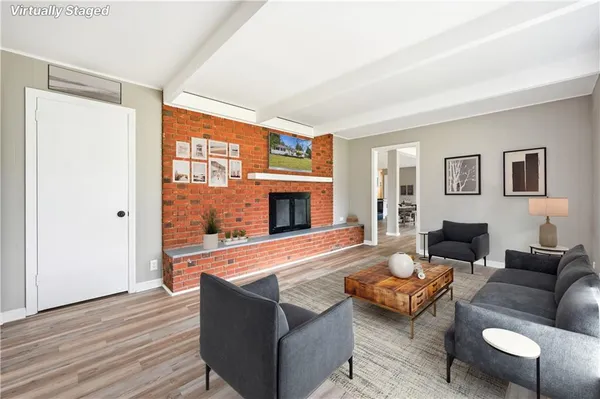 a living room with furniture wooden floor and a fireplace