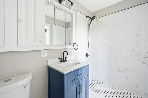 a bathroom with a sink a vanity and a mirror