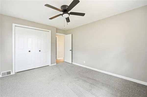 an empty room with a ceiling fan and a ceiling fan