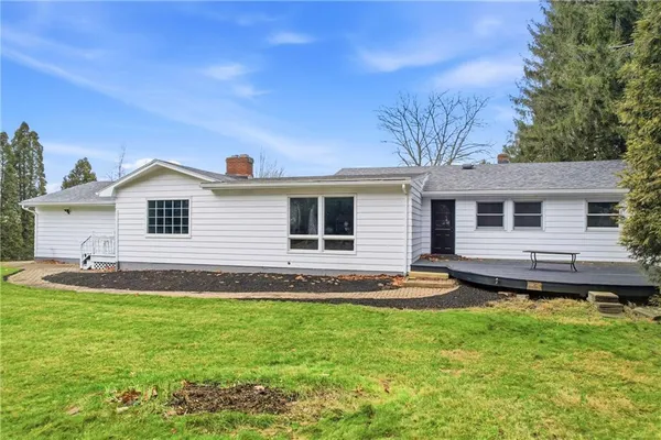 a backyard of a house with yard and outdoor seating
