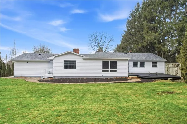 a view of a yard in front of a house with large tree