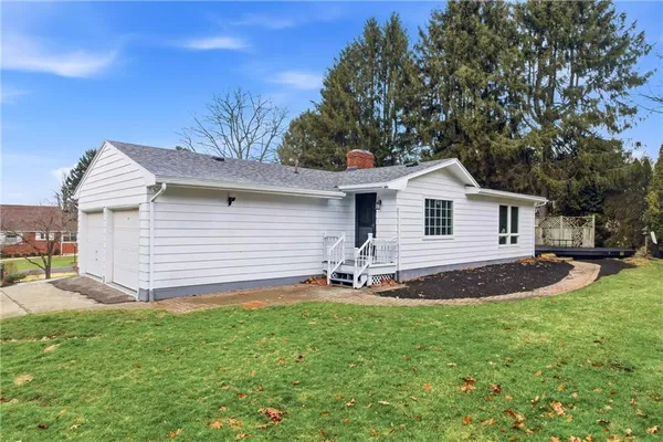 a backyard of a house with table and chairs