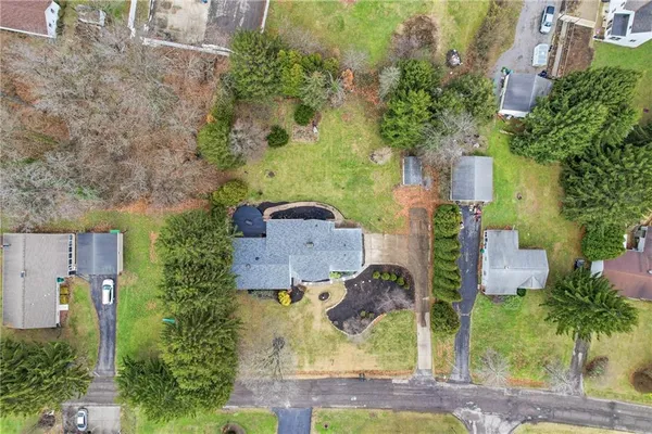an aerial view of a house with a yard