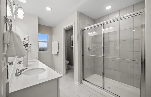 a bathroom with a shower sink and mirror