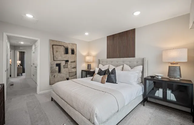 a bedroom with a bed and a lamp