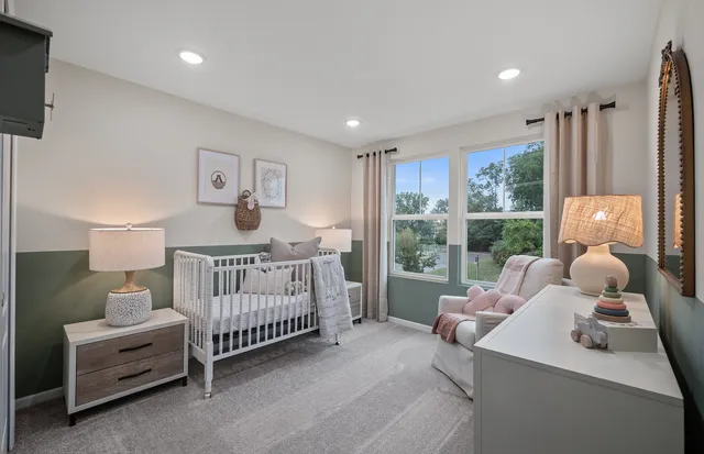 a bedroom with furniture and a large window
